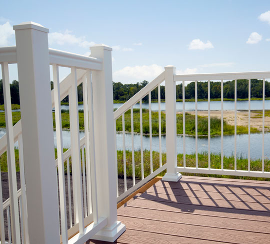 White vinyl railing and gate on a deck overlooking the water