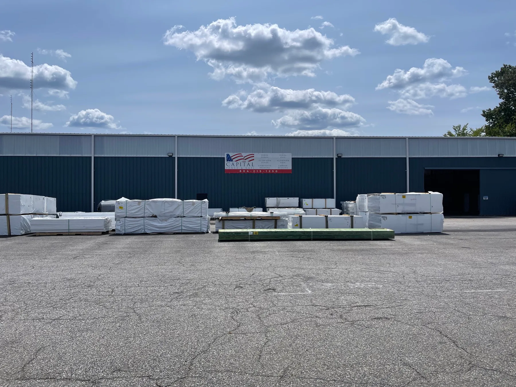 Richmond warehouse with wrapped fence and rail material staged outside